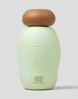 Green bottle with brown cap on a white background