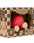 Red ball with wooden wheels in a branded box on a white background