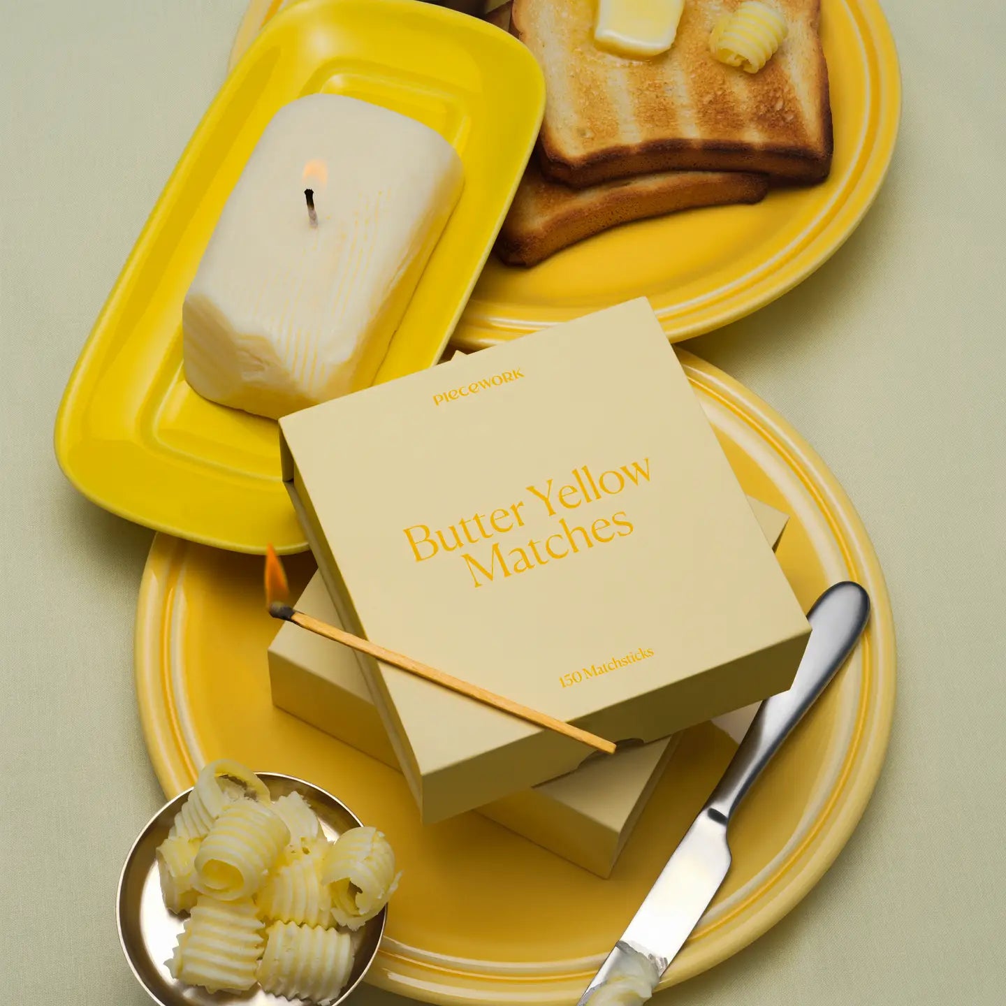 Butter yellow matches on a plate with toast and butter
