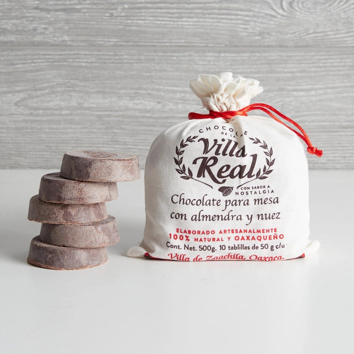 Villa Real chocolate packaging with stacked chocolate pieces on a wooden background