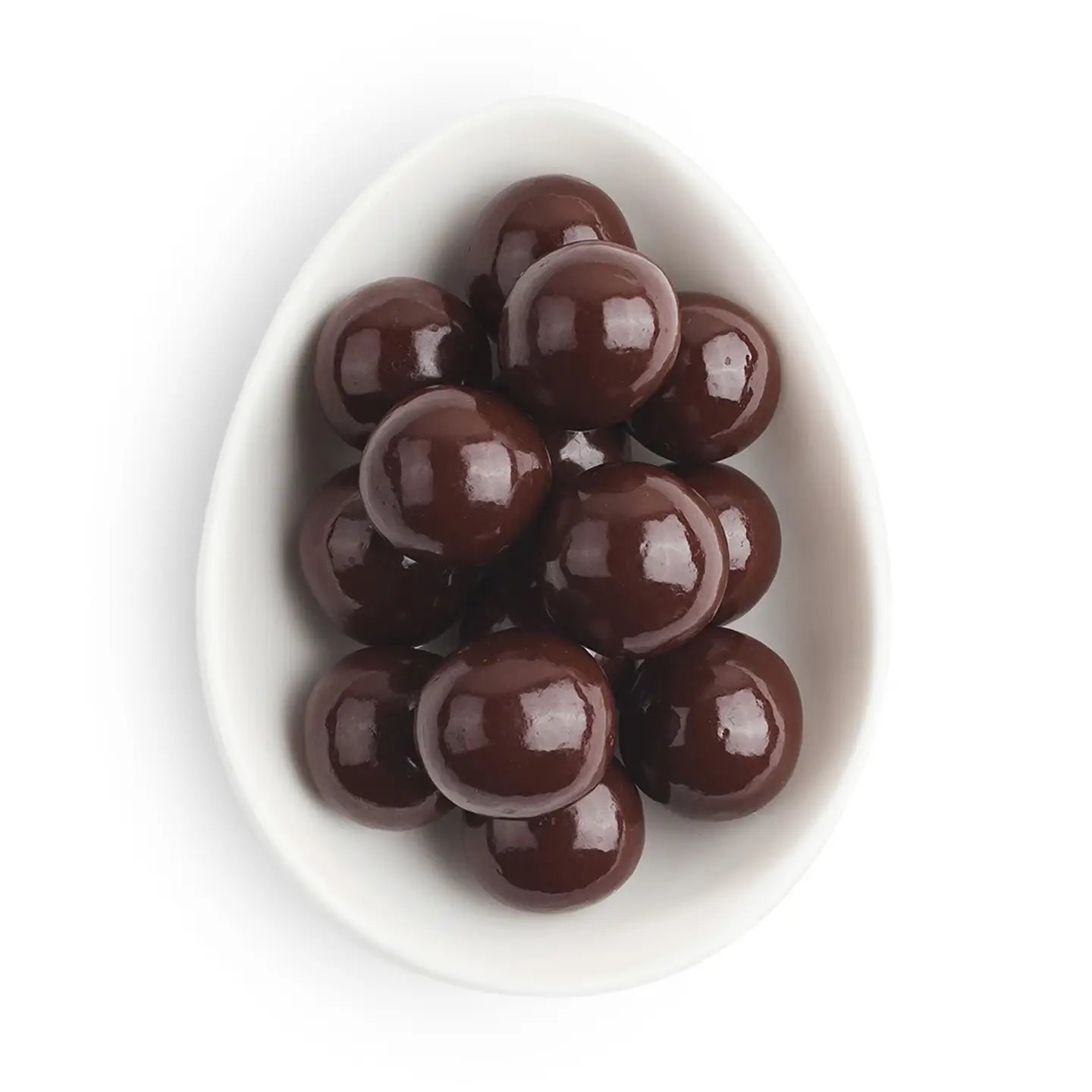 Chocolate candies in a white bowl on a white background