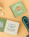 open football baby book surrounded by popcorn and a foam finger