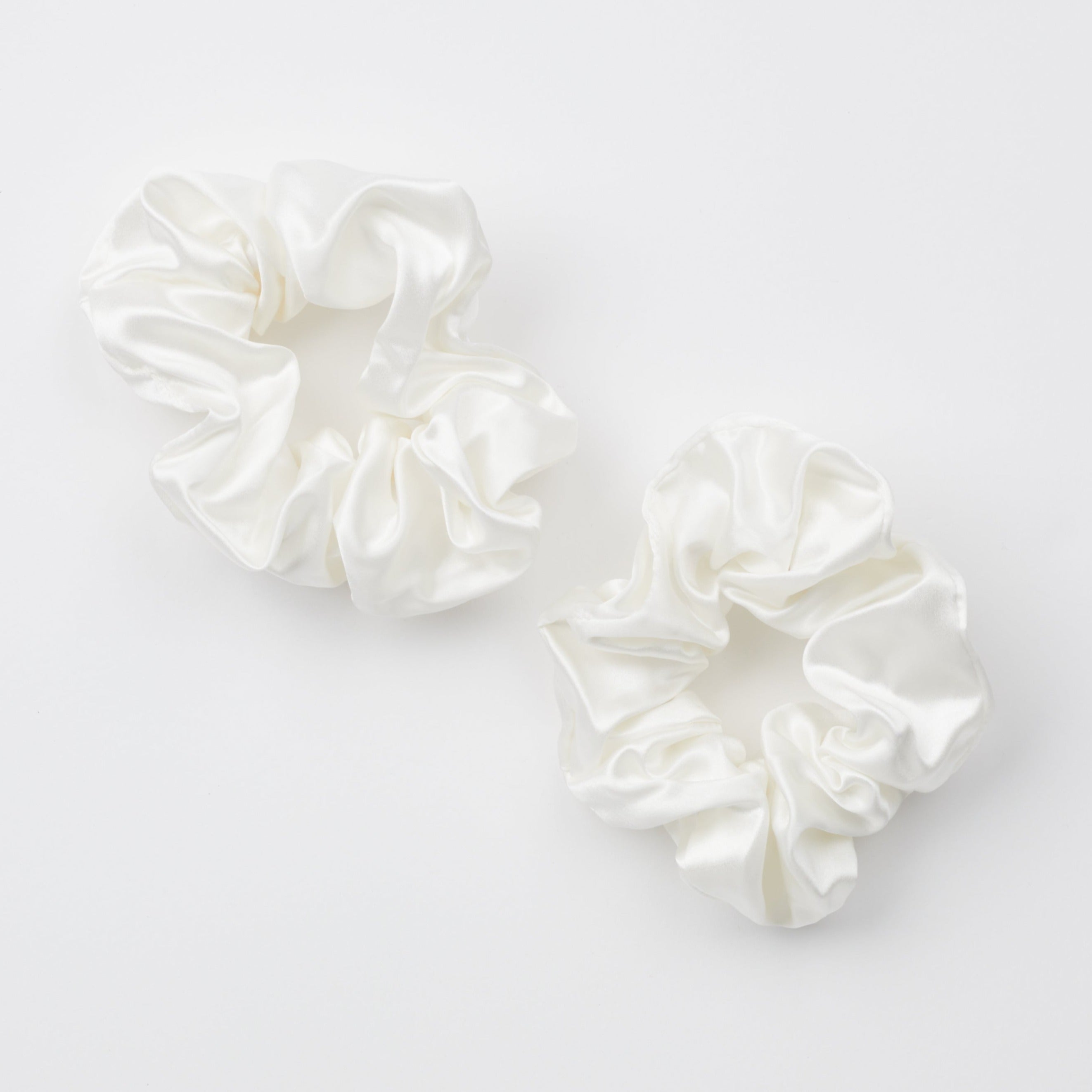 Two ivory thick silk scrunchies on white background.