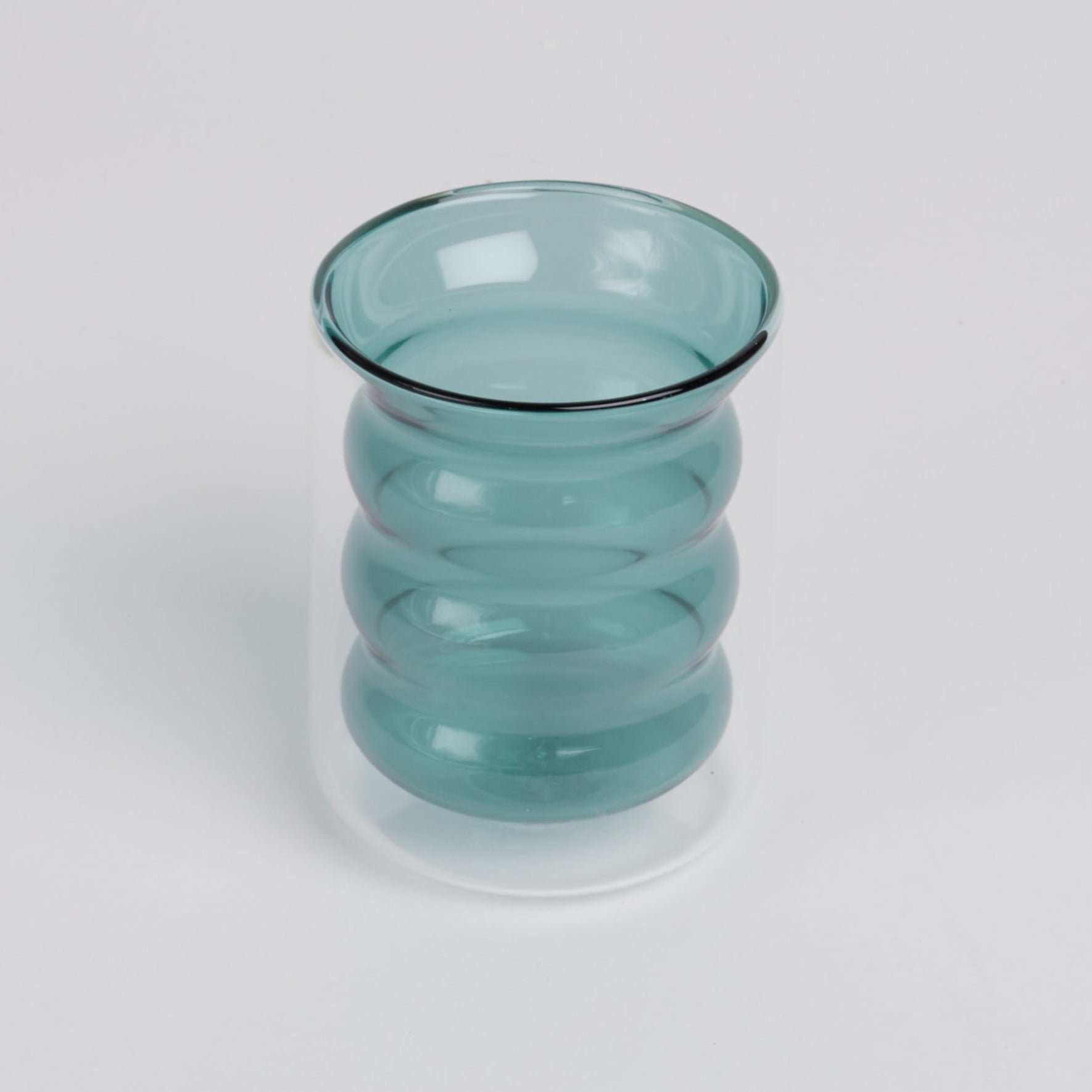A teal ripple glass on a white background.