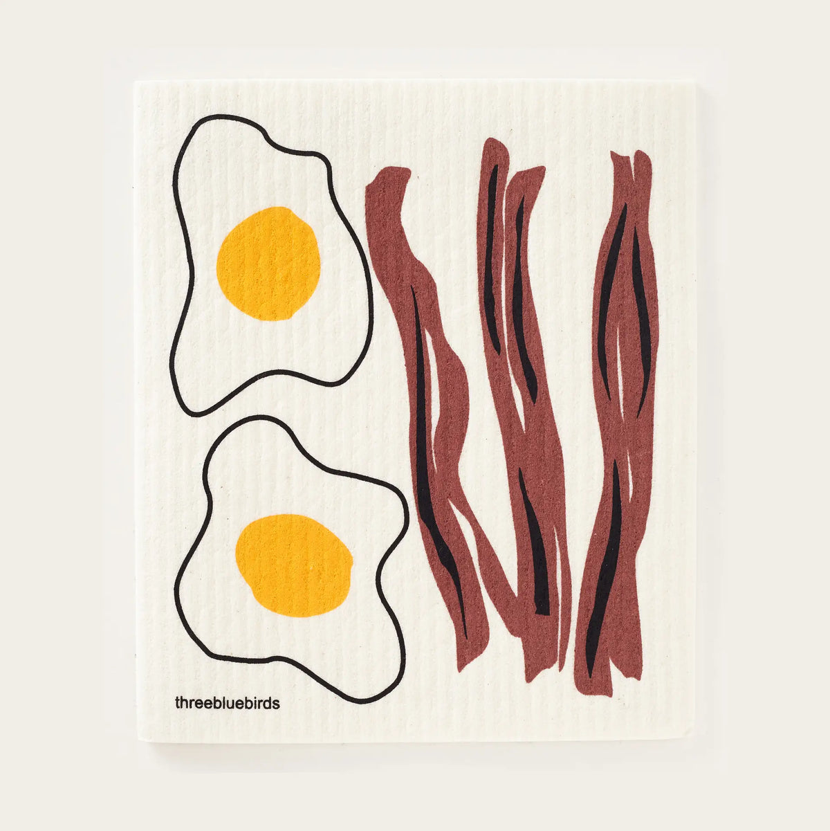bacon and eggs swedihs dishcloth on a white background