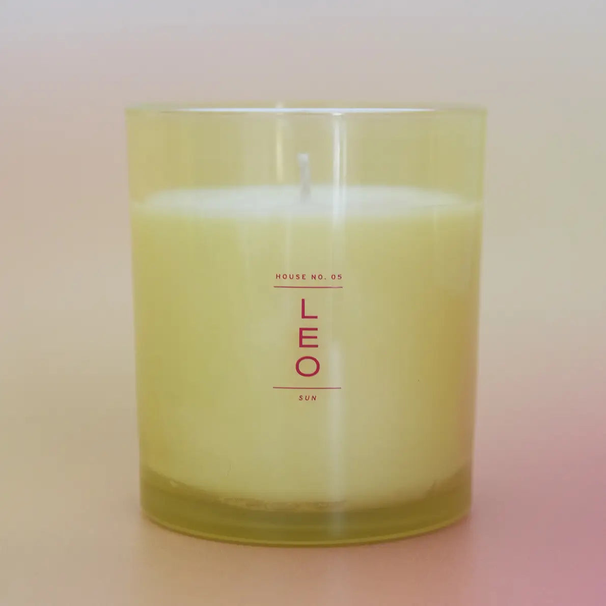yellow leo candle on a pink and yellow candle 