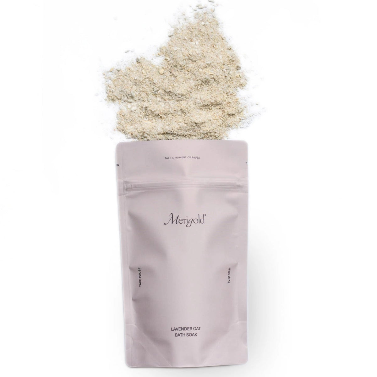 Purple package of Merigold bath salts with a small amount of product on top against a white background