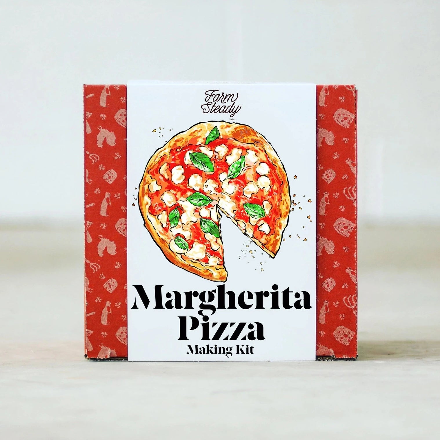 red square box with food illustrations printed on it. box has white label with pizza illustrated in the center and black text below it