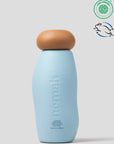 Blue bottle with brown cap on a light gray background