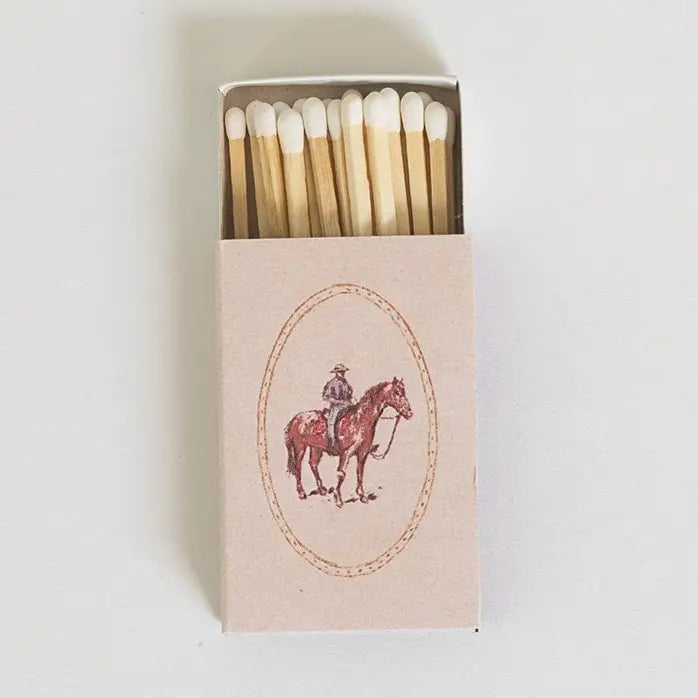 Matchbox with a horse and rider illustration on a white background