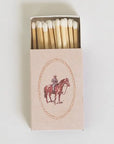Matchbox with a horse and rider illustration on a white background