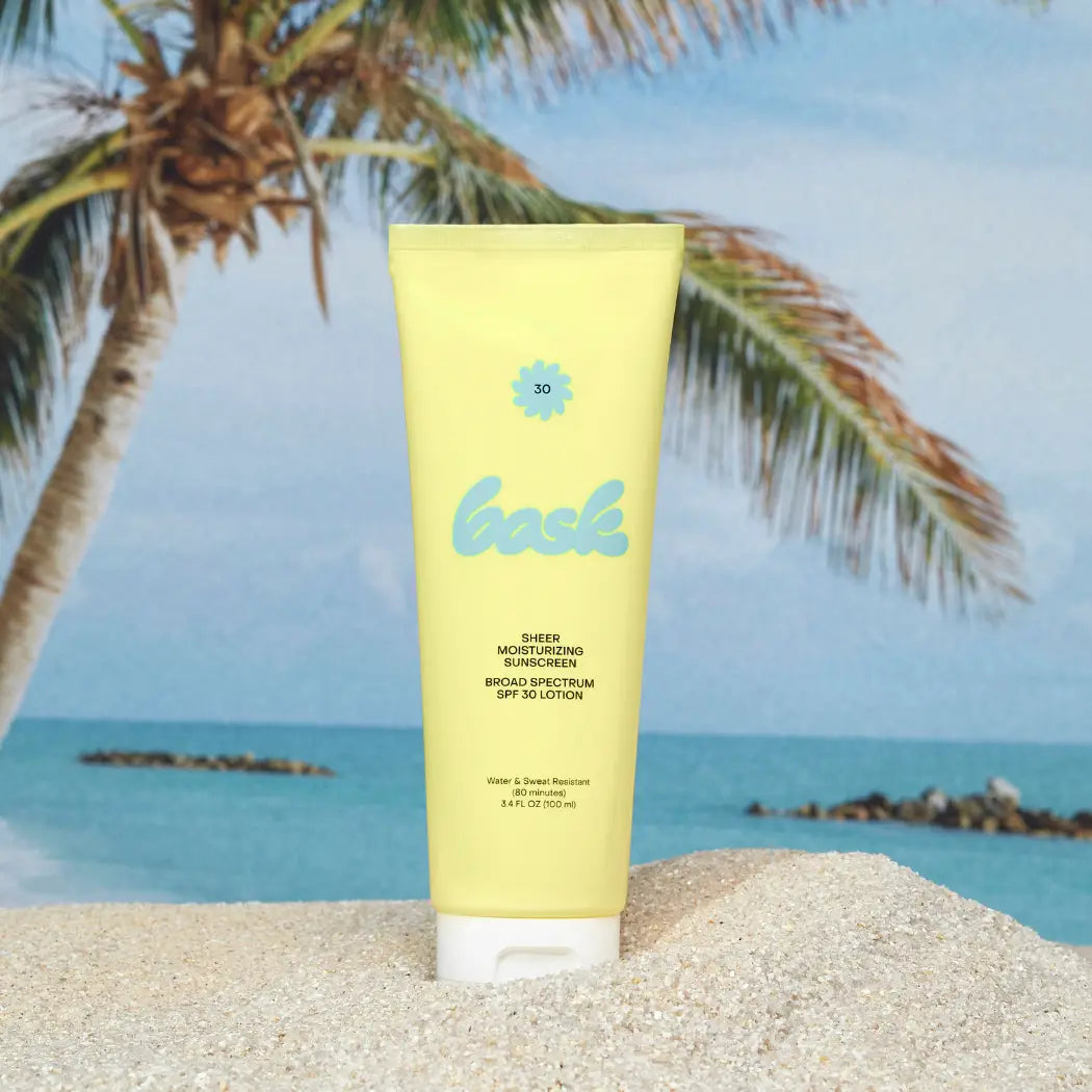 Yellow sunscreen tube with palm tree and beach background