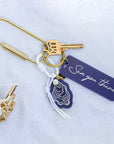 oyster bag charm on gold key ring