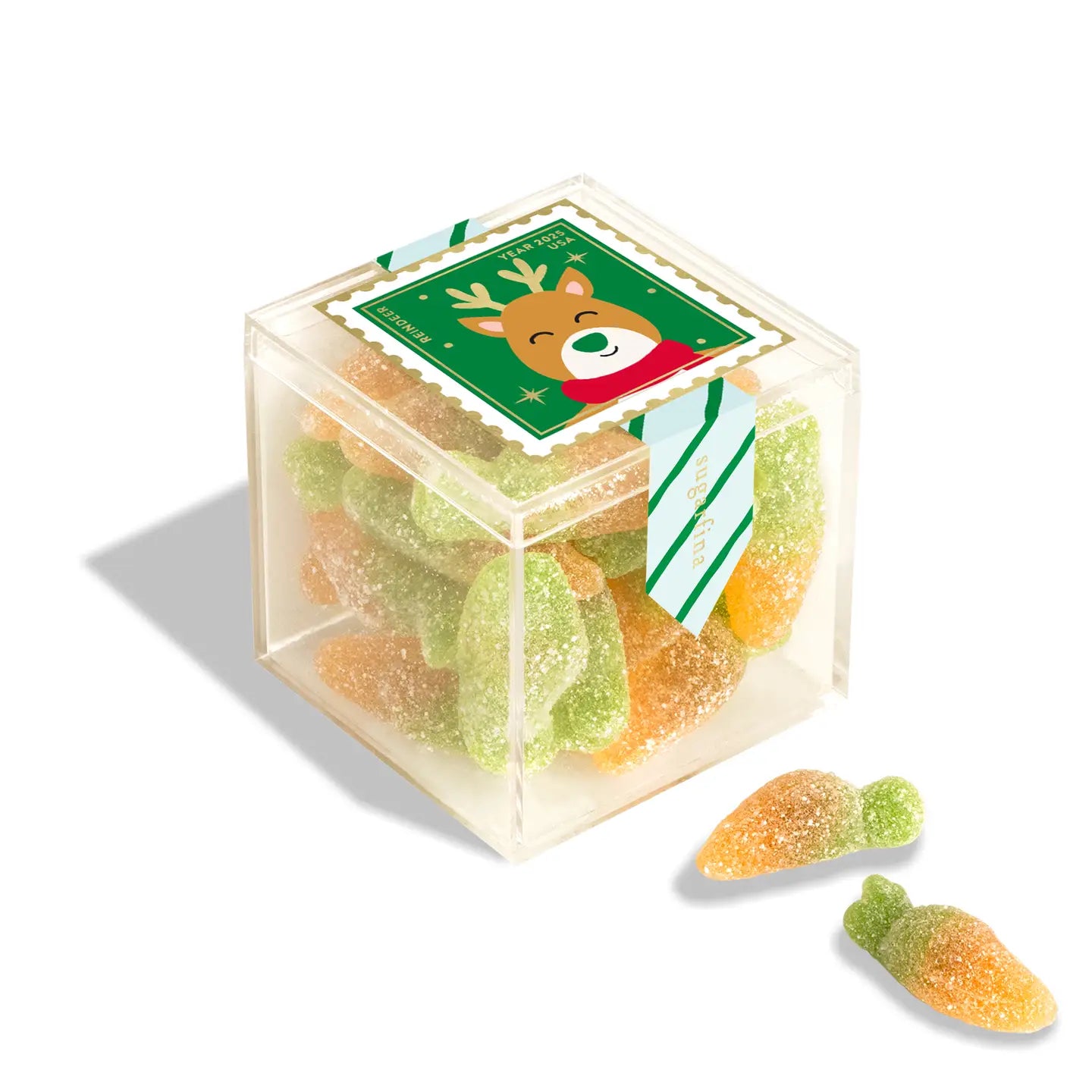 Hexagonal clear candy box with gummy candies and a reindeer label on a white background