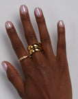 Hand showing stacked chunky gold ring