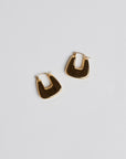 Gold Stirrup earrings on white background