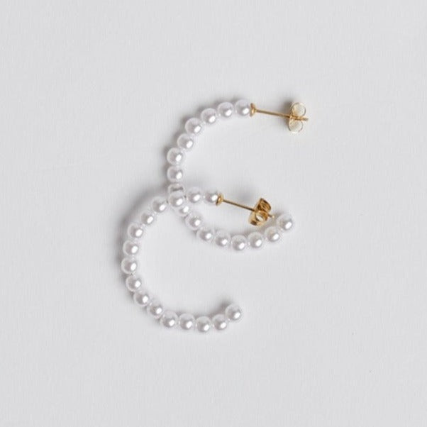 Pearl hoop earrings on white