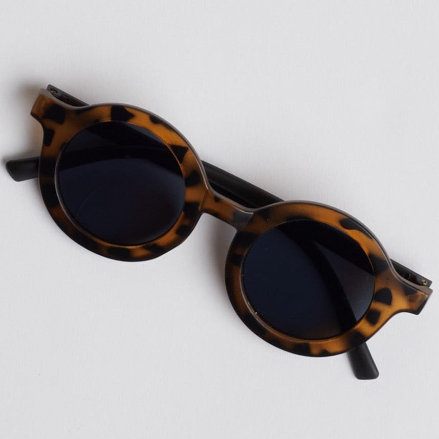 Brown baby tortoise shell sunglasses on white