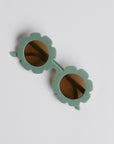Green floral sunglasses on white