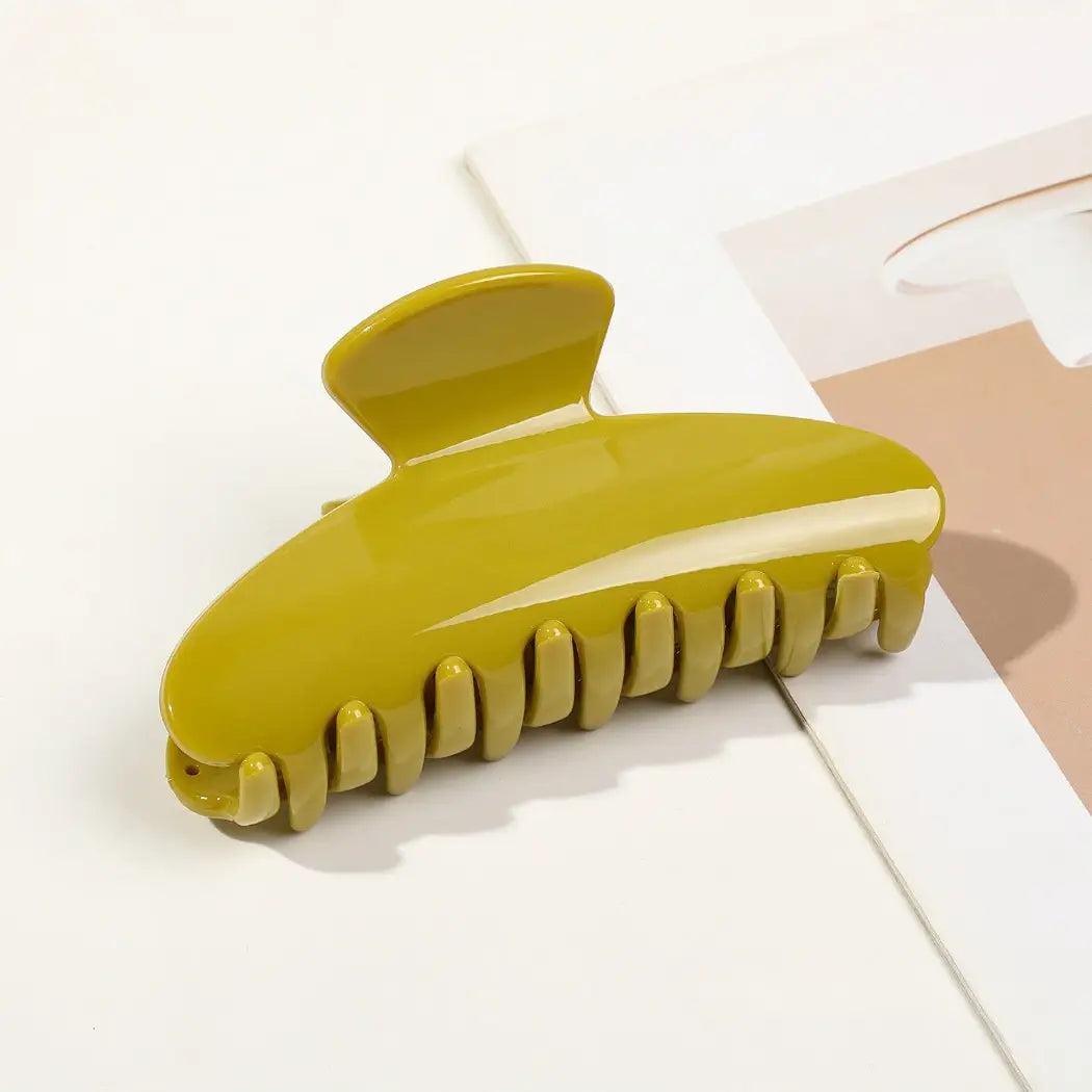 Yellow hair clip on a white surface
