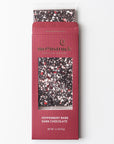 Peppermint Bark Dark Chocolate" bar from Moonstruck, with a maroon packaging design. The bar itself has a speckled look with pieces of white and red peppermint on dark chocolate