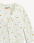 Baby onesie with fruit pattern on a white background