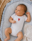 blue baby bodysuit with a red lobster on a baby