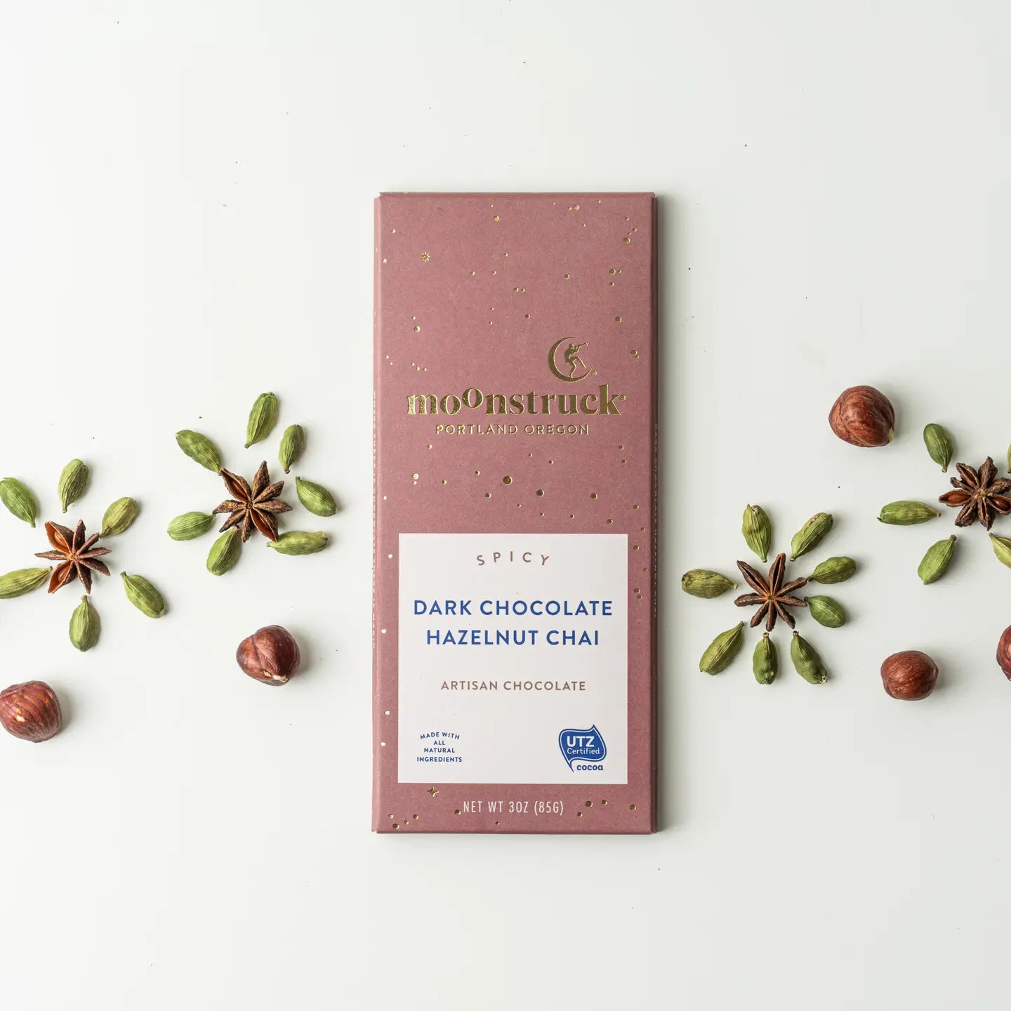 Moonstruck Spicy Dark Chocolate Hazelnut Chai bar with decorative elements on a white background