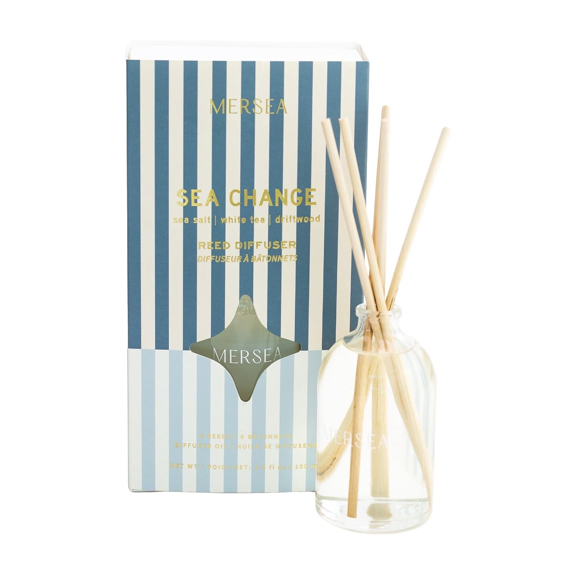 blue vertically striped box with gold text. reed diffuser in front of it