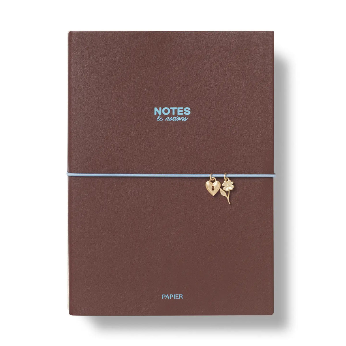 A brown textured hardcover notebook with a light blue elastic band and small gold charms, on a white background.