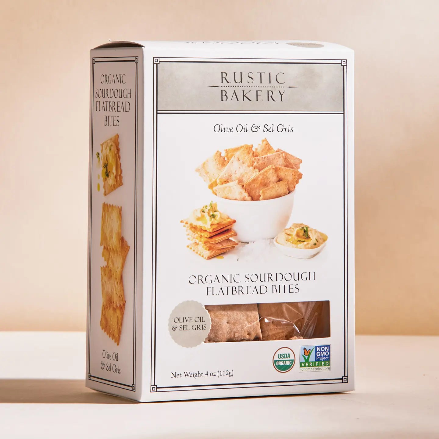 Box of Rustic Bakery Organic Sour Dough Flatbread Bites on a beige background