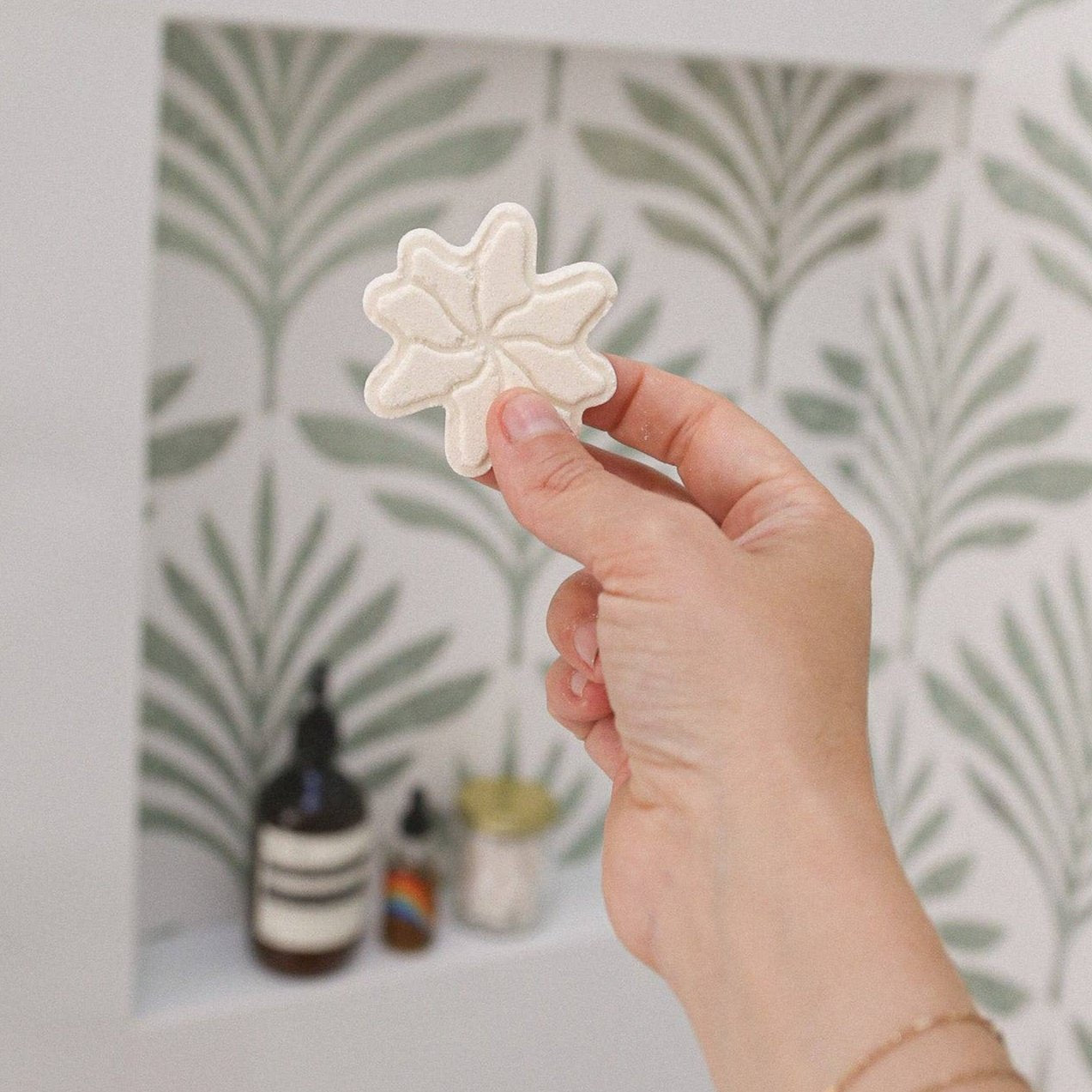 hand holding star-shaped shower steamer