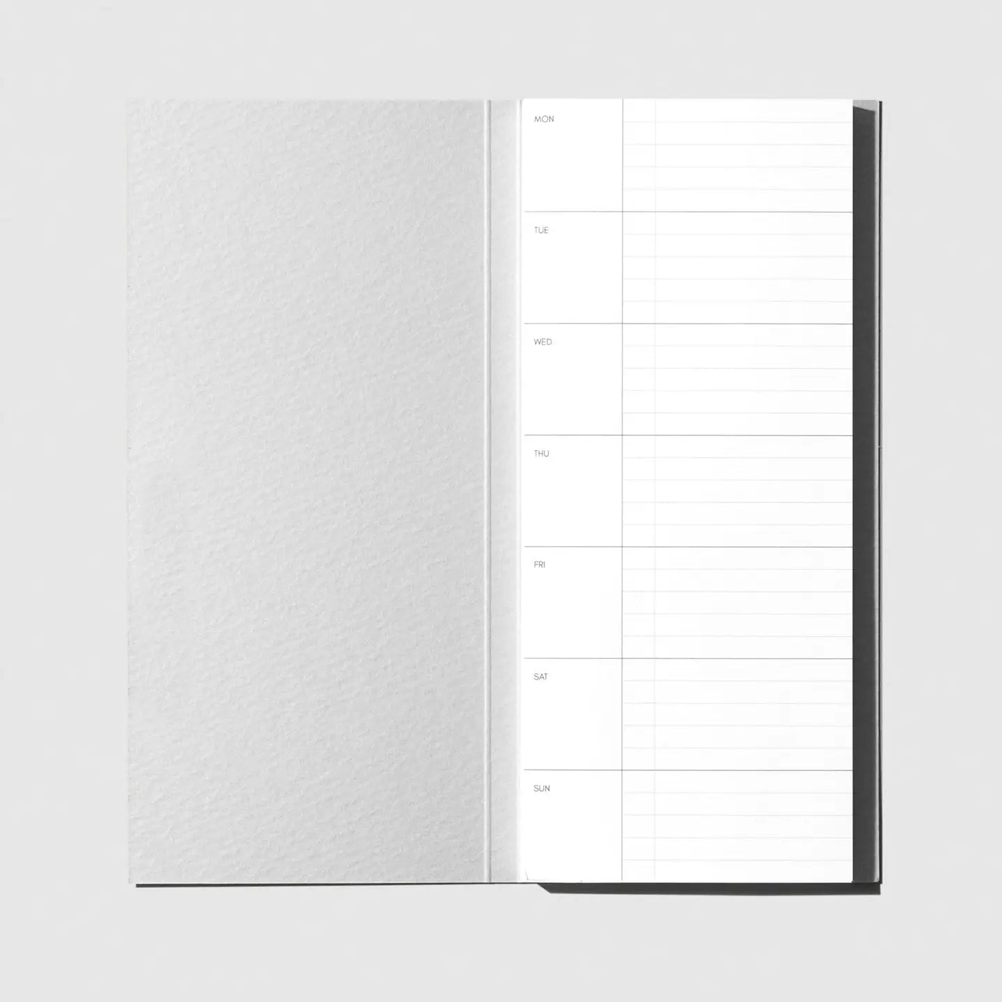 Open notebook with lined pages on a white background