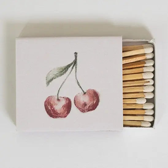 Matchbox with cherry design on the cover and matches inside