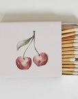 Matchbox with cherry design on the cover and matches inside