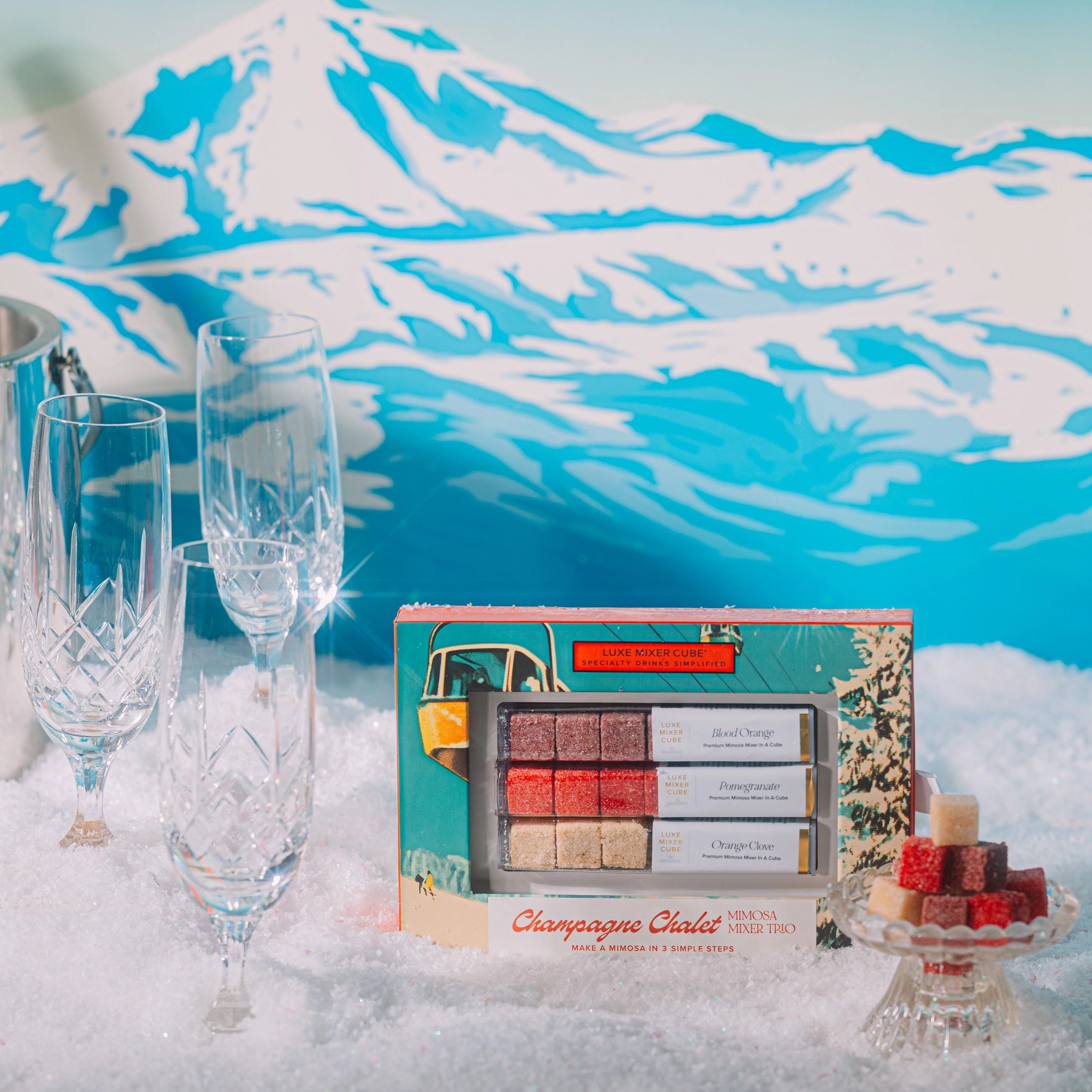 Makeup palette with champagne flute design on a snowy mountain background