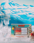 Makeup palette with champagne flute design on a snowy mountain background
