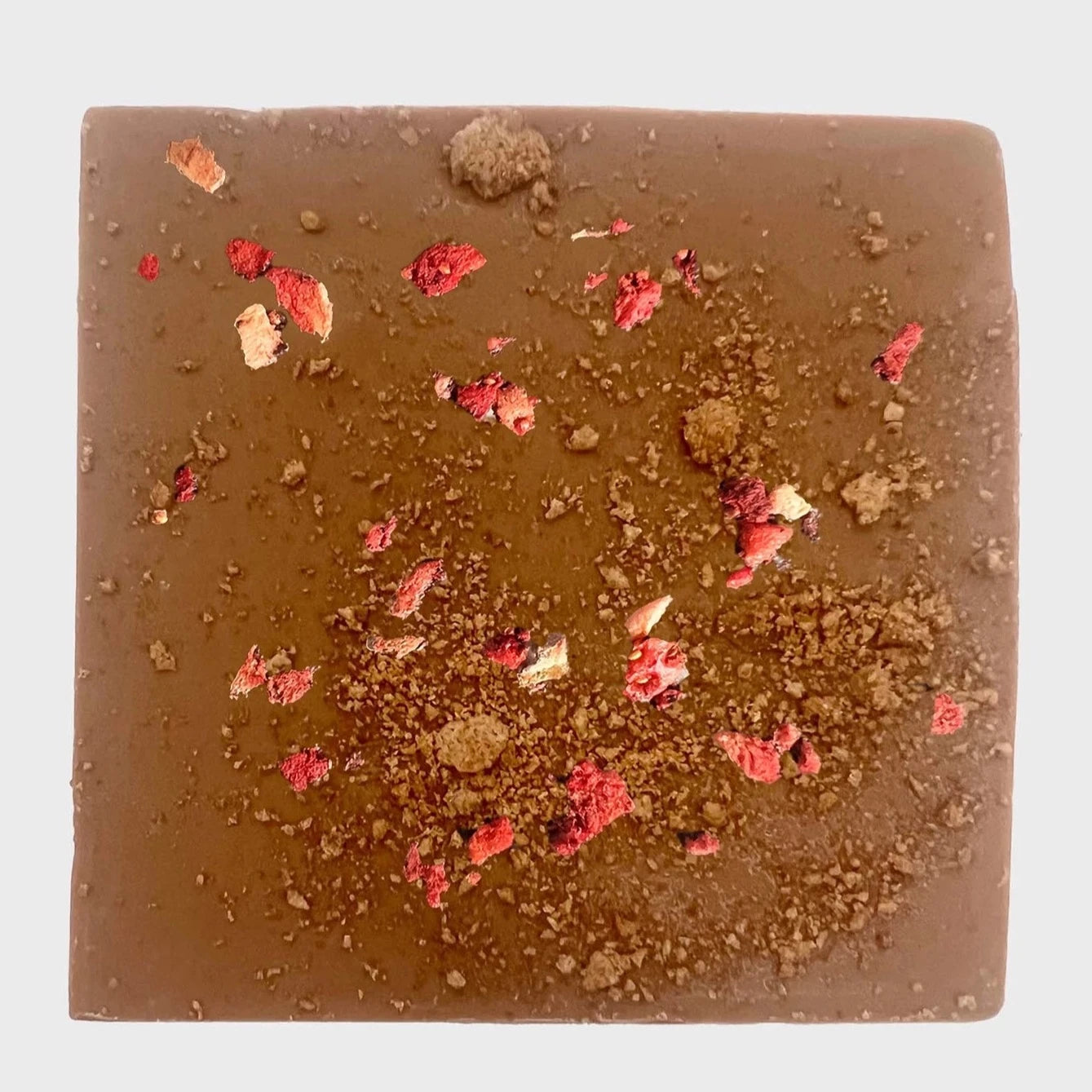 square chocolate with bits of dried strawberry sprinkled throughout it 