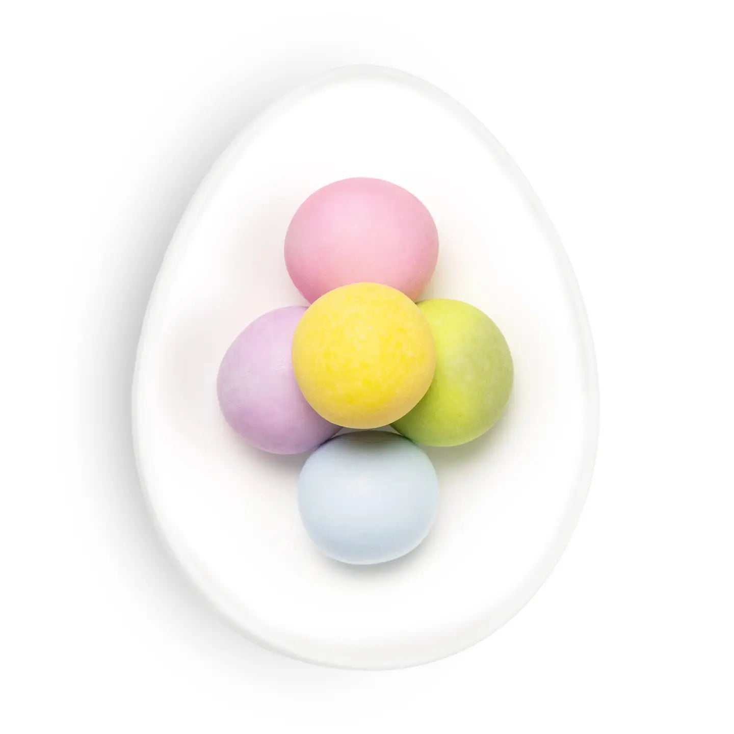 Pastel-colored Easter eggs on a white plate with a white background