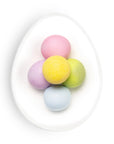 Pastel-colored Easter eggs on a white plate with a white background