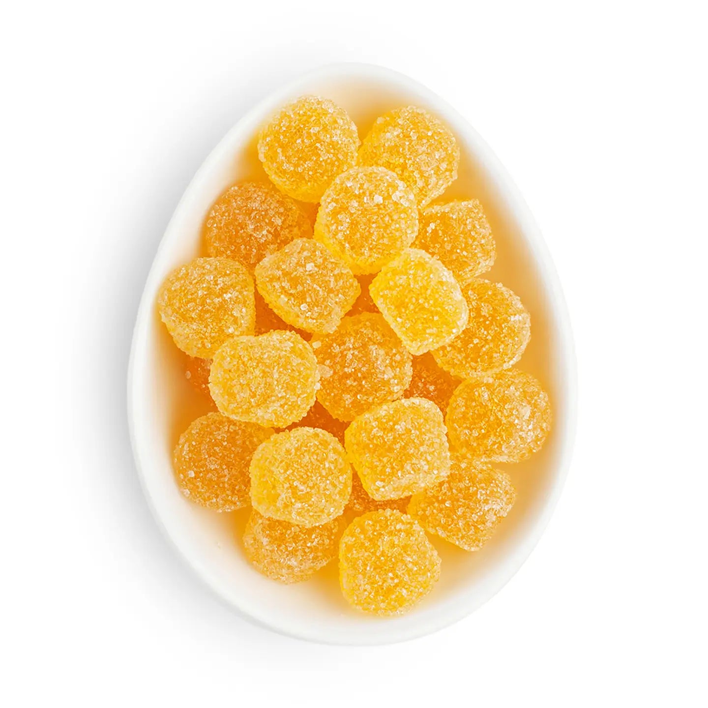 White bowl filled with yellow gummy candies on a white background