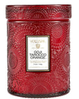 Red embossed glass candle. Embossed is a large floral print. Has white label with a black and gold border. Black text inside with scent name