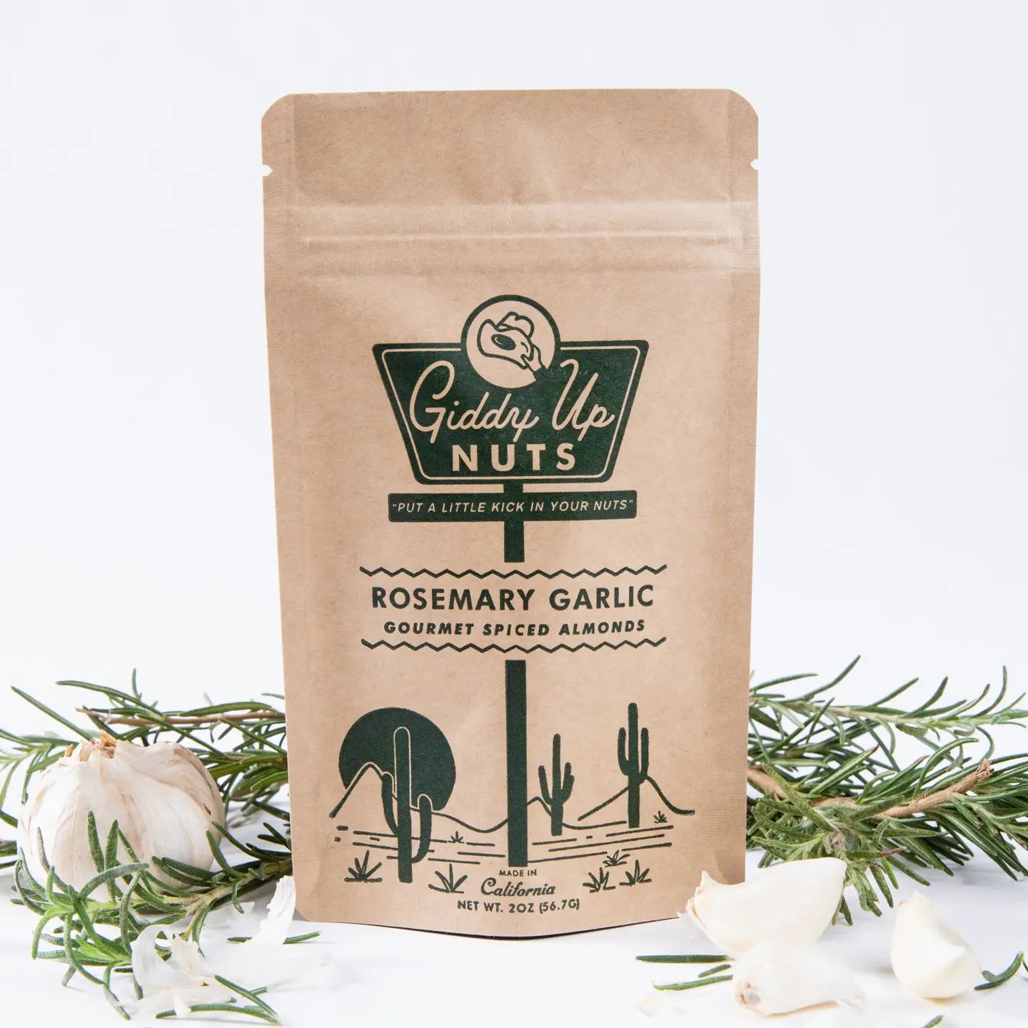 Kraft paper packaging of Giddy Up Nuts Rosemary Garlic almonds with decorative elements on a light background