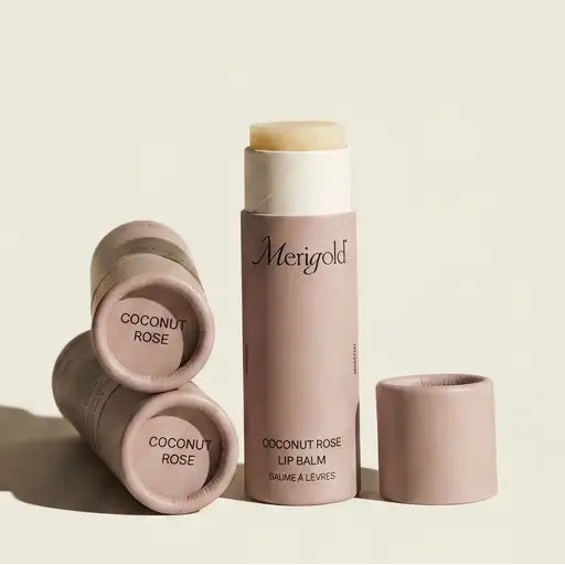 Lip balm with 'Menegold' branding on a beige background