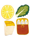 Set of colorful kitchen pot holders shaped like a lemon, leaf, Parmesan cheese, and baguette on a white background.