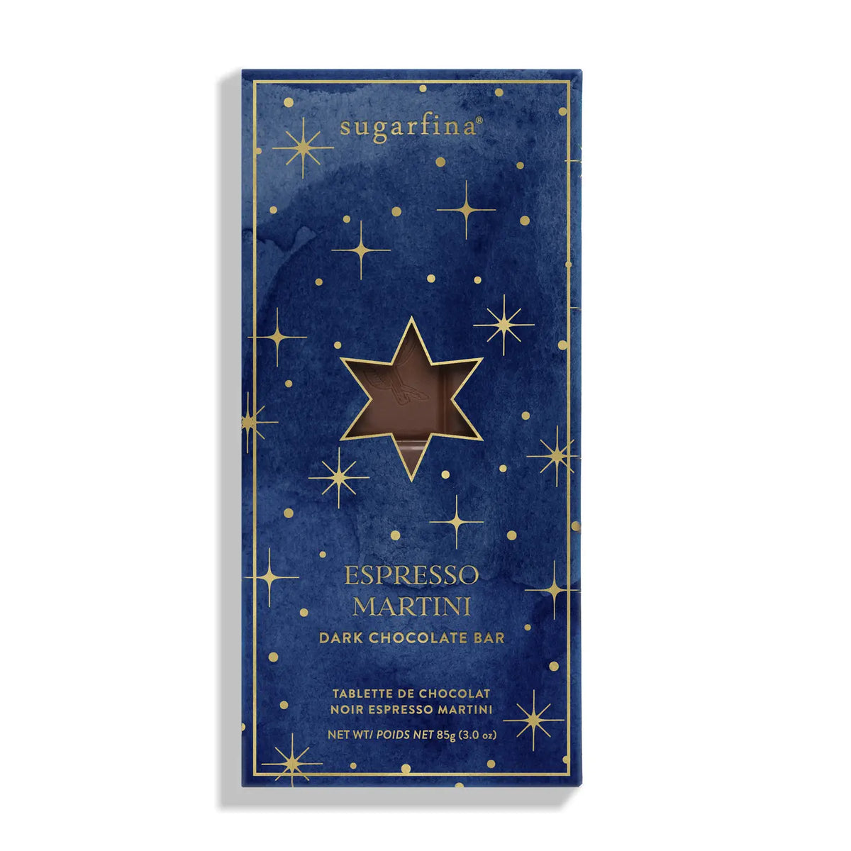 A single packaged chocolate bar package standing upright on a white background. The front is dark navy blue with a gold border, scattered gold stars, and a large central gold star containing a brown chocolate window.