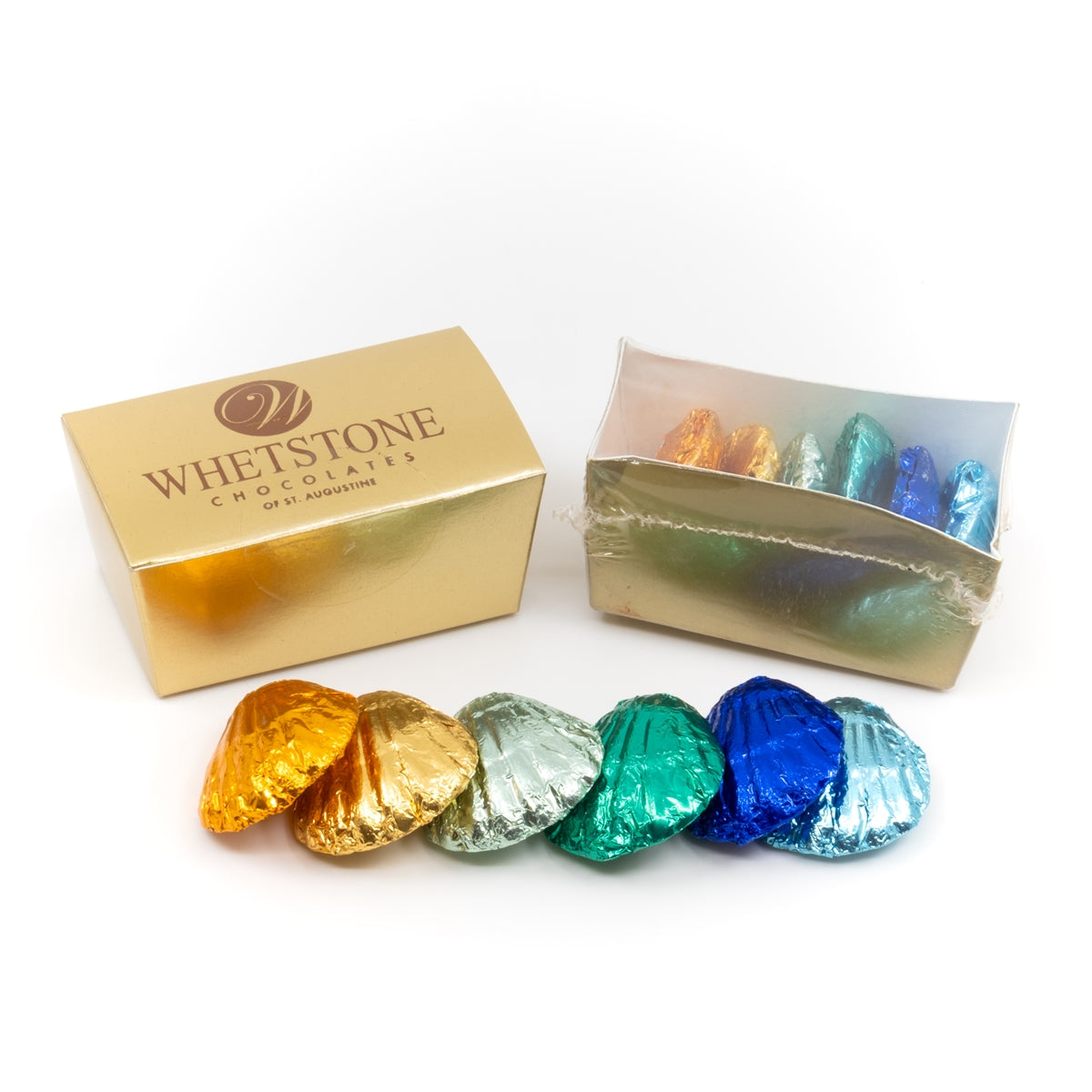 Colorful chocolate candies with a gold Whetstone Chocolates box on a white background
