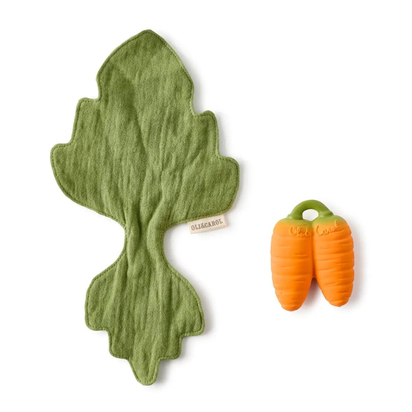 Green leaf-shaped toy and two orange carrot-shaped toys on a white background