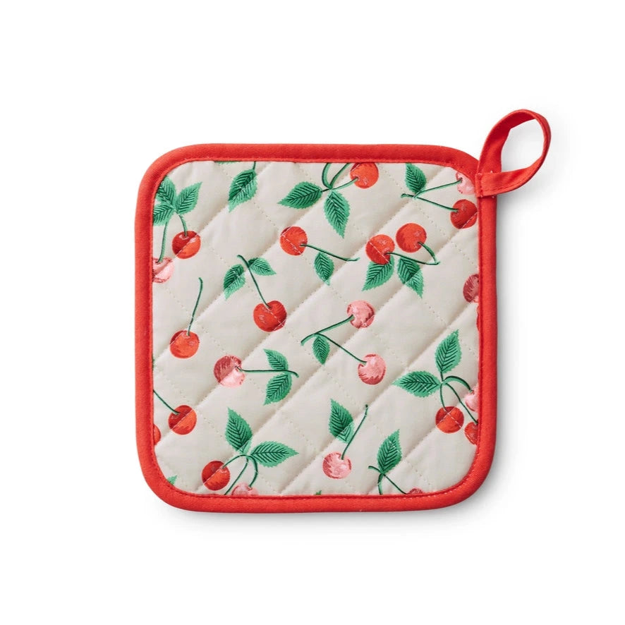 The cherry-patterned pot holder is displayed flat, highlighting the quilted cherry design, vibrant red trim, and practical loop for easy hanging.