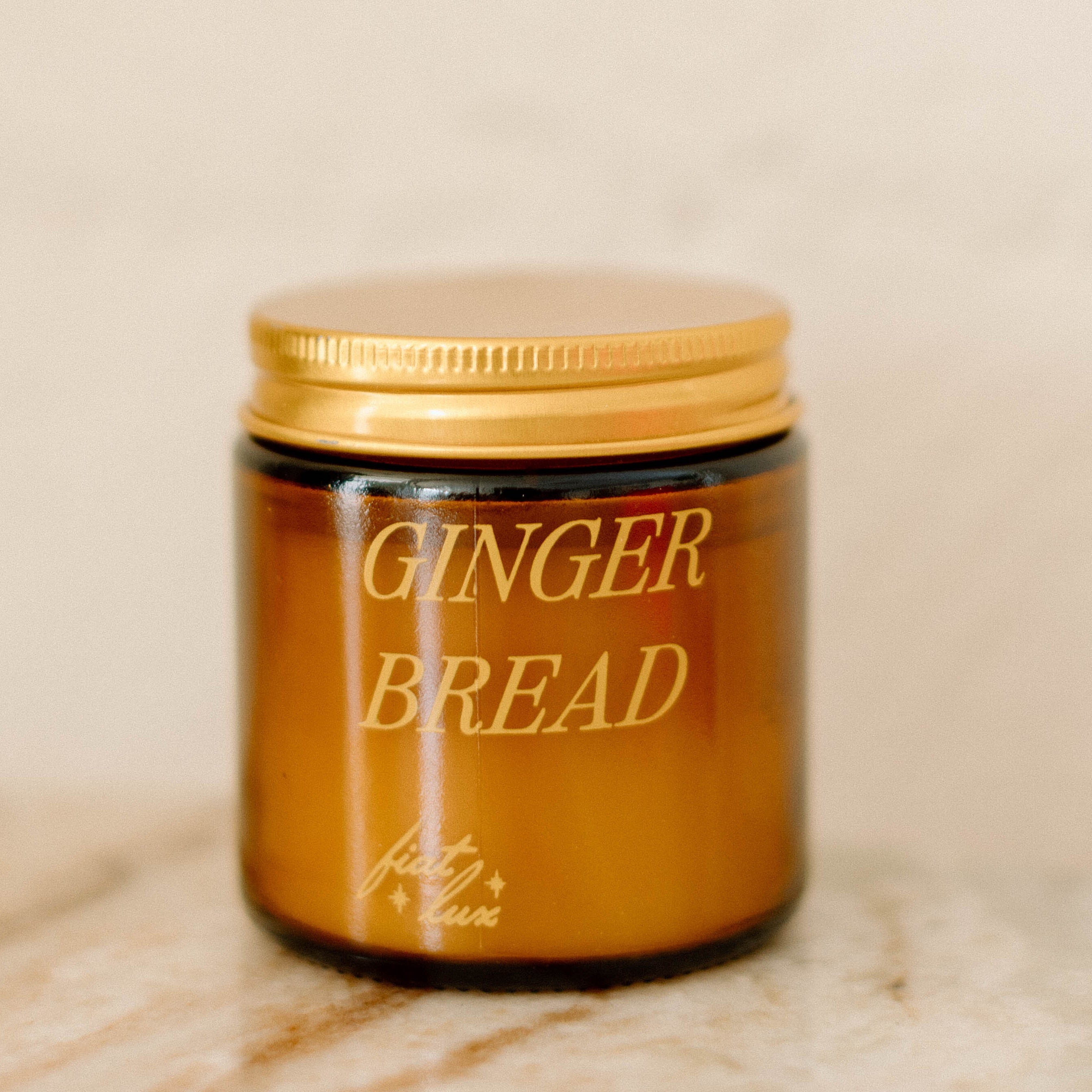 mini amber candle jar with 'GINGERBREAD' printed on it